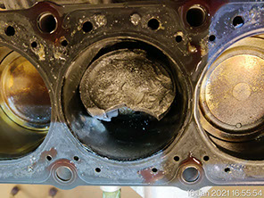 Damaged piston after a valve broke down inside that cylinder